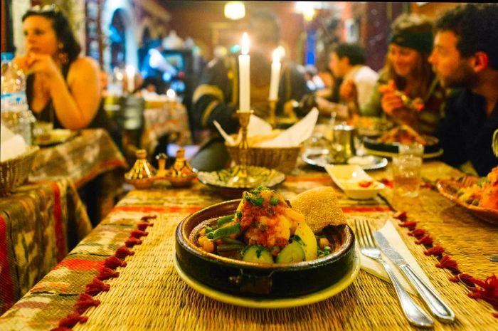 A classic Moroccan dish served on a table in a bustling restaurant