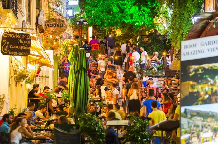 Crowds gather around tables that spill uphill from the restaurants