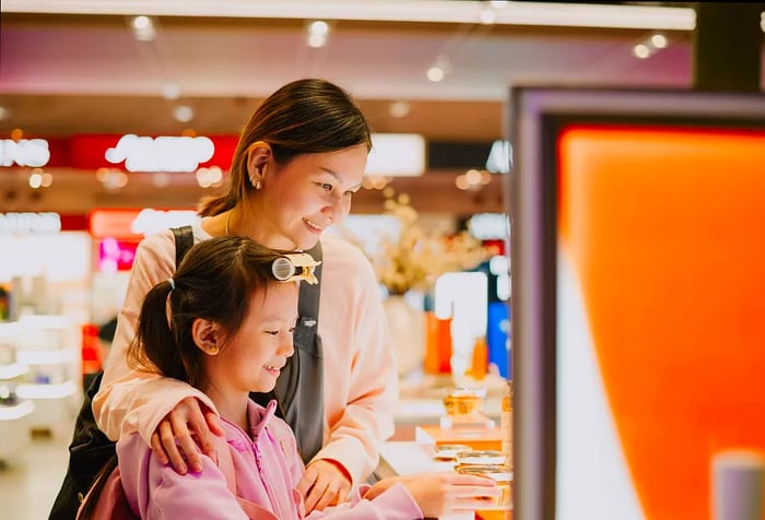 Asian mother and daughter shopping at the airport