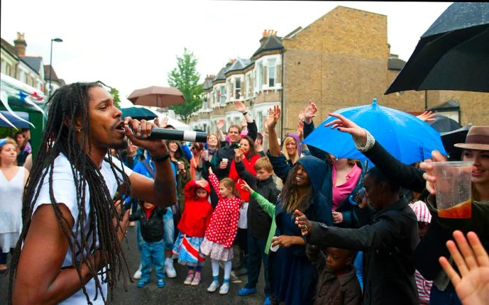 Revellers celebrate a Diamond Jubilee street party in the rain in Brixton, London, England, United Kingdom