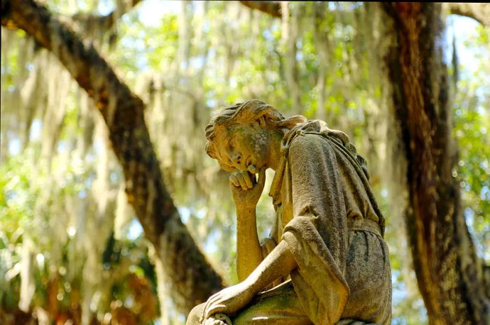 A mourning sculpture at Bonaventure Cemetery in Savannah