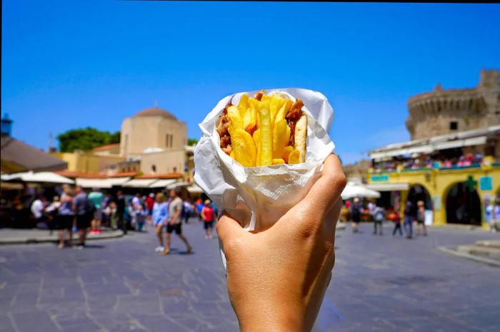 Greek gyros wrapped in pita, set against the backdrop of a historic Greek square