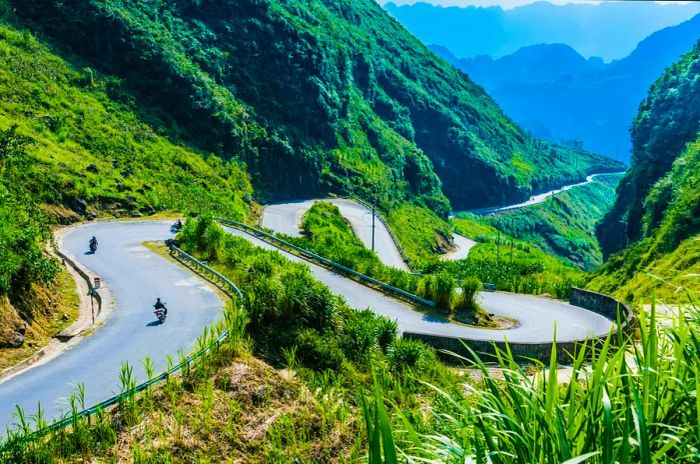 A winding switchback road in the lush green Ha Giang province in Vietnam