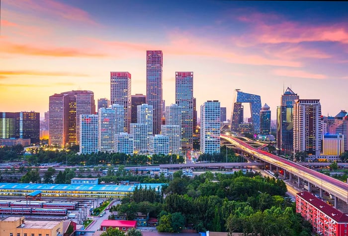 The skyline of Beijing's central business district, featuring an impressive elevated bridge that elegantly crosses the bustling cityscape.