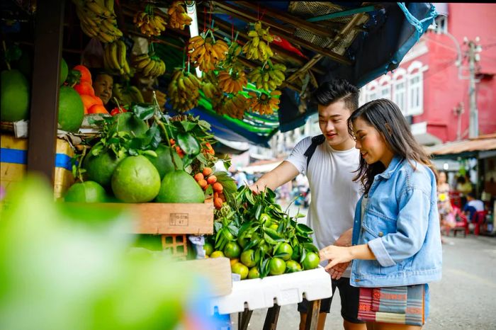 A young Asian couple exploring a local market in Ho Chi Minh City, Vietnam