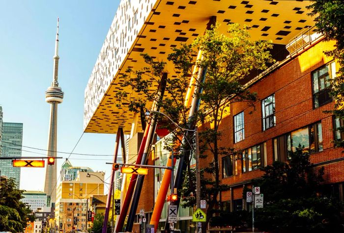 The CN Tower and the distinctive main structure of OCAD University loom over the streets of downtown Toronto.