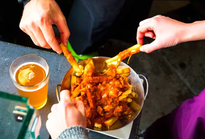 Après-ski snacks: Enjoying beer and poutine at the pub along with savory bar bites.