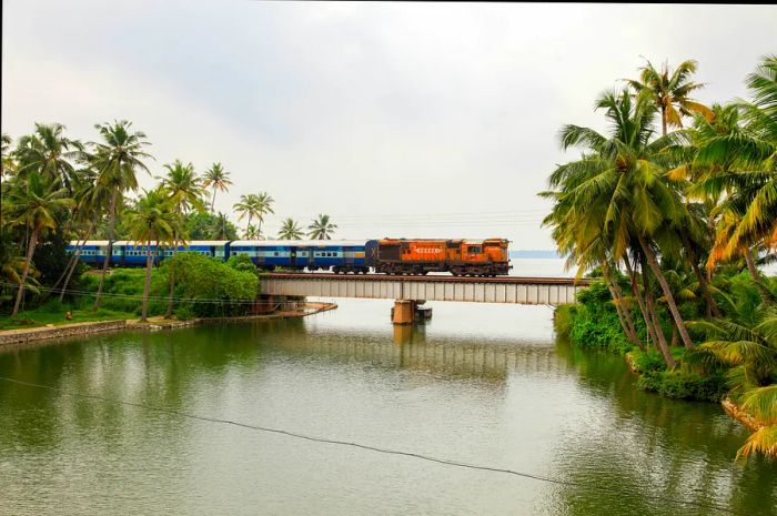 A train traverses a railway bridge on Manroe Island in Kollam, Kerala, India