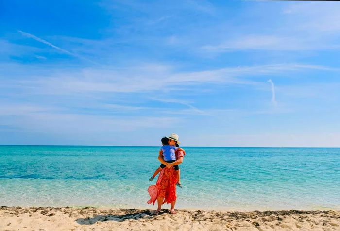 A mother and her child relish a day at the beach in Nassau, Bahamas.