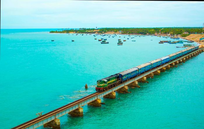 A train traverses the Pamban Bridge, connecting Rameswaram on Pamban Island to mainland India.