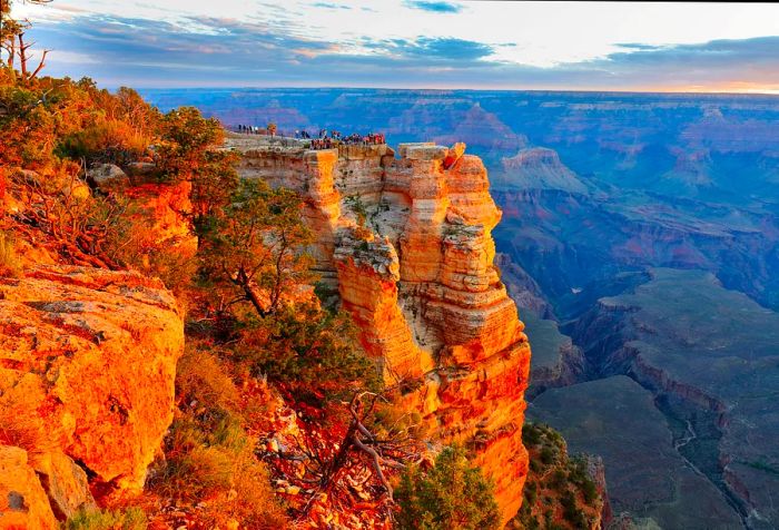 Visitors at a scenic overlook enjoy breathtaking views of the magnificent Grand Canyon, a true natural wonder.