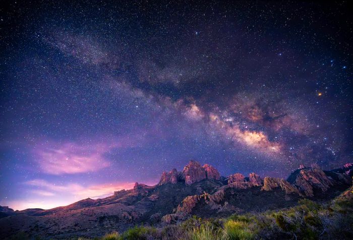 Rocky desert mountain range beneath the starry sky