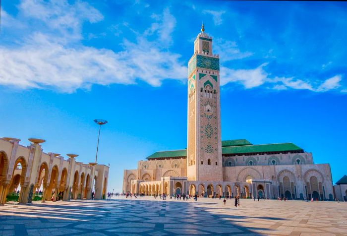 The magnificent Hassan II Mosque, adorned with intricate Moroccan artistry, features an impressive minaret that reaches high into the sky.