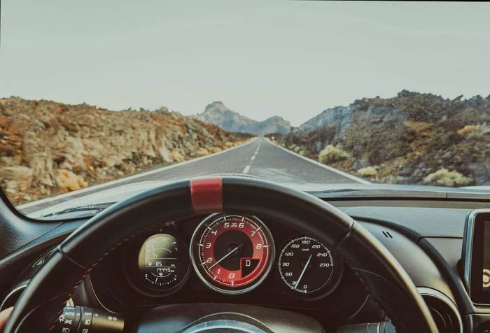 A view of the rocky mountain road from inside the vehicle.