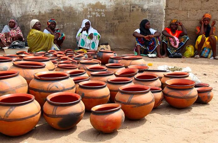 Nigerian women display their pottery for sale at the weekly market in Yola.