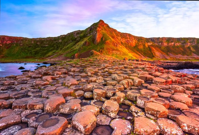 The coastline features remarkable interlocking basalt columns at the Giant's Causeway, framed by dramatic cliffs.