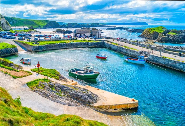 A captivating stock image of the scenic Ballintoy Harbour along the Causeway Coast in Northern Ireland, UK, under a bright sunny sky.