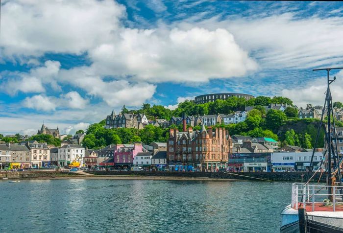 A charming village by the coast features houses nestled along the shoreline.