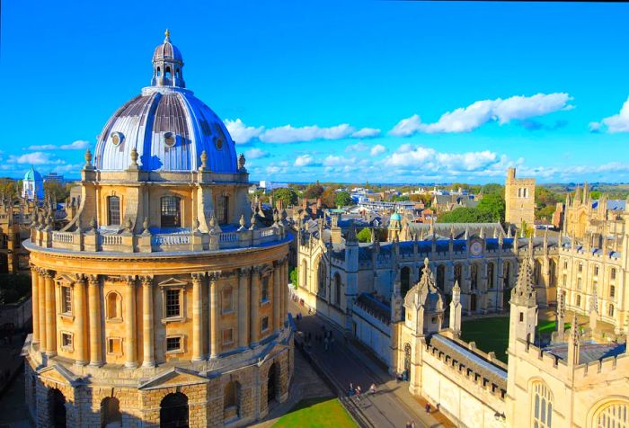 A domed Palladian-style academic library adjacent to a Gothic-style college building with a quadrangle.