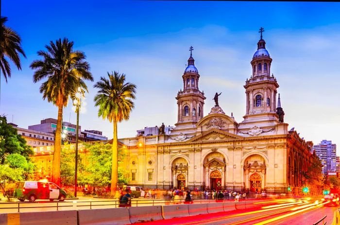 A long exposure captures the flow of traffic and pedestrians at Plaza de Armas in Santiago, Chile.