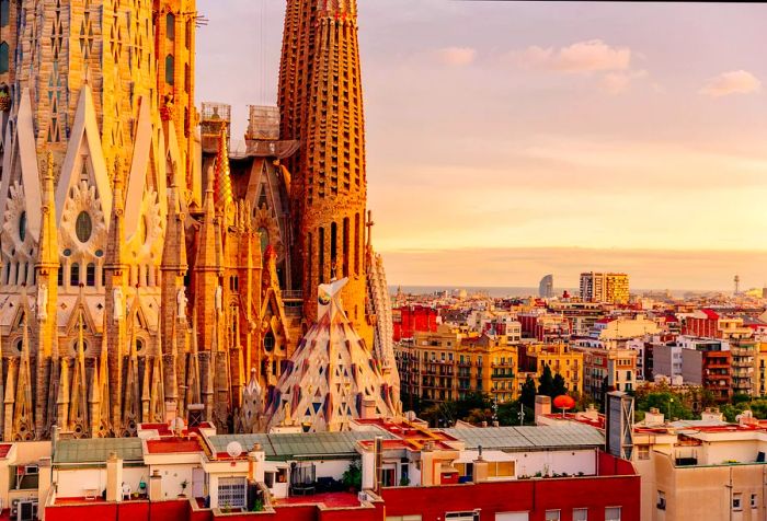 The magnificent Sagrada Familia rises majestically above the surrounding buildings and homes.