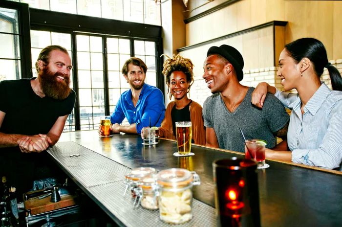 A group of friends enjoying a laugh with the bartender