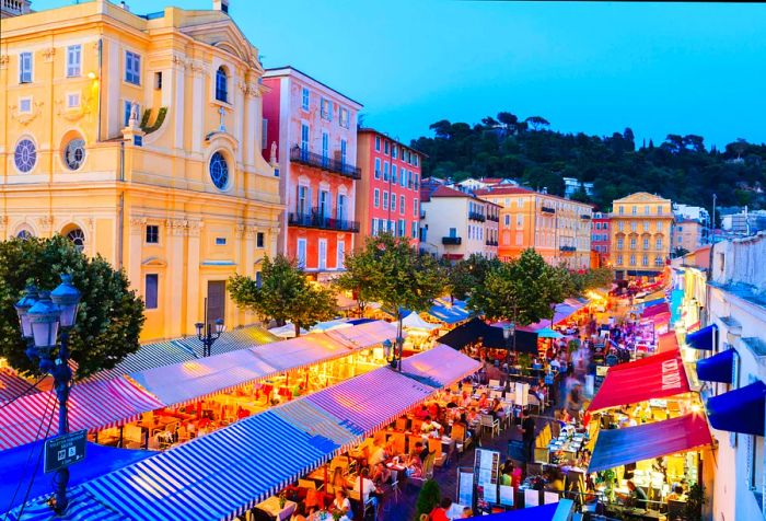 An aerial perspective of bustling outdoor dining spots surrounded by classic, vibrant architecture.