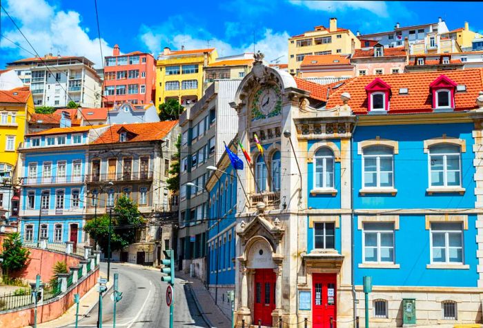 Historic buildings with vibrant facades lining a steep street.