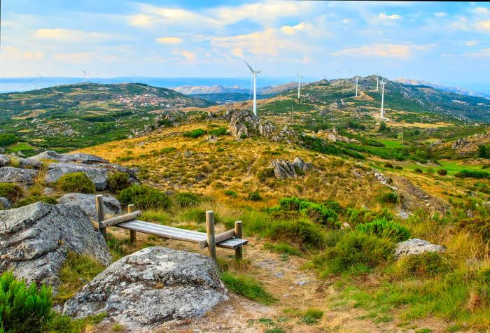 A viewpoint showcasing mountains adorned with windmills.