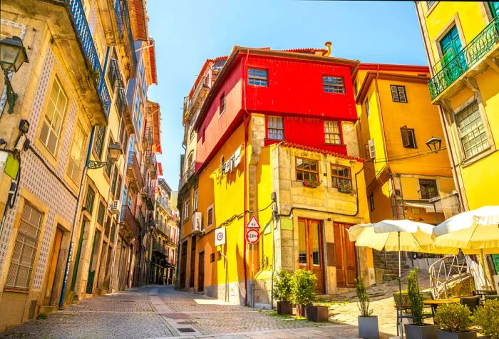 Charming traditional houses with vibrant colors line a picturesque street.