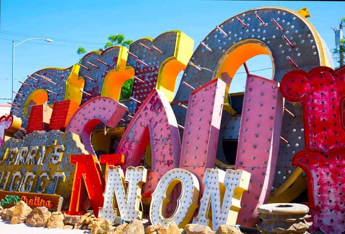 A chaotic array of marquee letters and storefront signs lining a debris-strewn path.