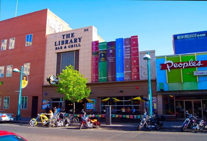 A contemporary bar and grill located on Historic Route 66 (Central Avenue) in downtown Albuquerque, New Mexico, features mock book titles that are clever food and drink puns. Albuquerque is a popular stop for Route 66 travelers in New Mexico.