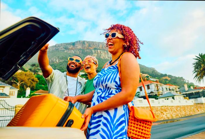 Three cheerful friends capture a joyful moment with a selfie during their travel escapade.