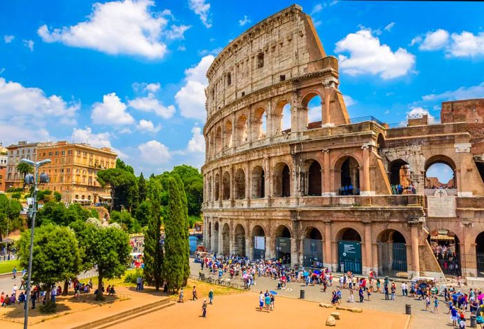 The Colosseum teeming with visitors on a bright, beautiful day.