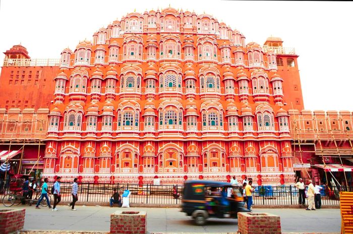 Visitors walking by the Palace of Winds (Hawa Mahal) in Jaipur, Rajasthan, India