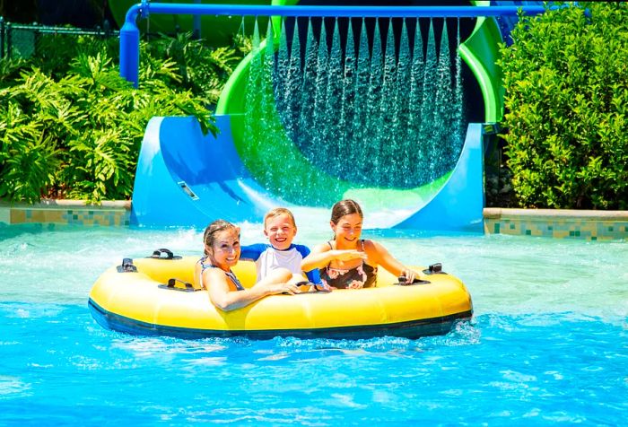 Joyful family of three enjoying the pool on a round inflatable raft.