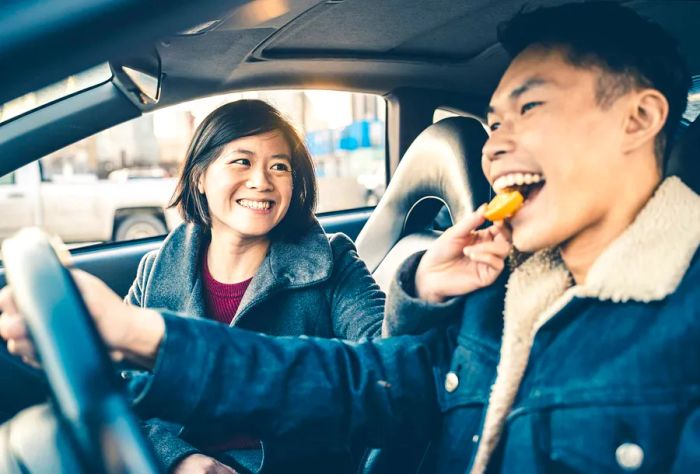 theme_car_roadtrip_friends_enjoying_food_gettyimages-1196246651_universal_within-usage-period_83130