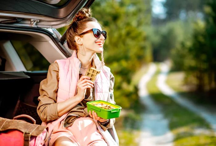 theme_car_roadtrip_friends_enjoying_packed_lunch_gettyimages-1141989773_universal_within-usage-period_83129