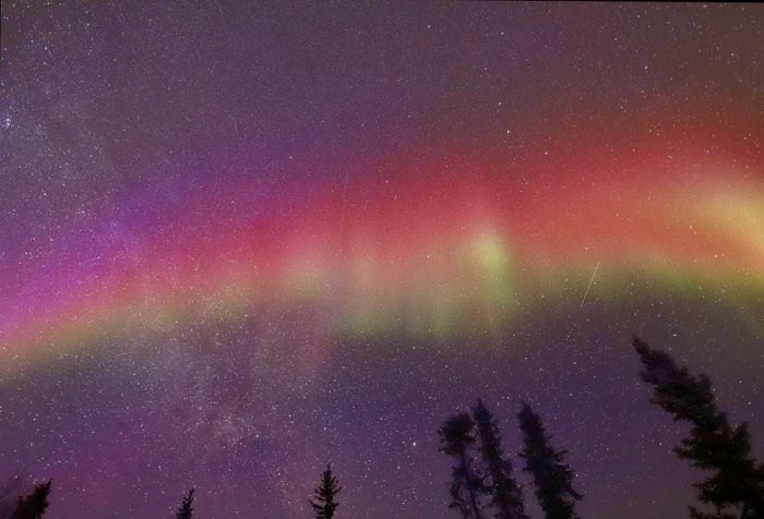 The mesmerizing Northern Lights shimmer against the starry sky.