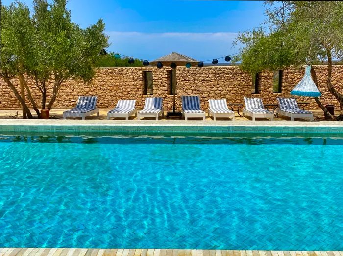 Poolside view and deckchairs at Jardins de la Villa