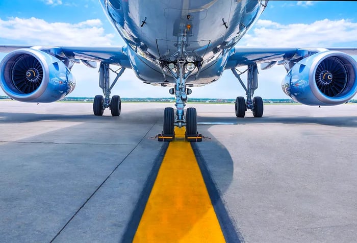 Jet engines quietly humming as they sit on the runway.