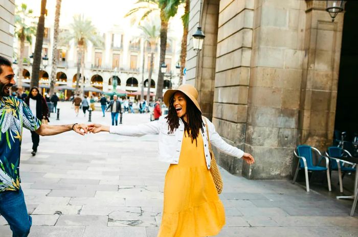 A young multiracial couple dancing in the heart of Barcelona, Catalonia