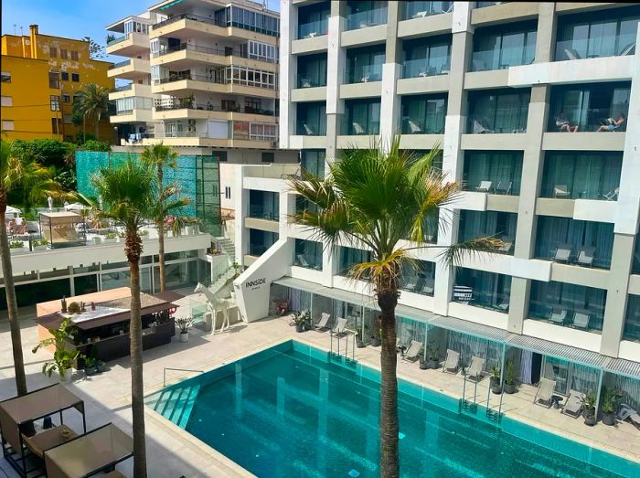 Balcony view of the pool and sun loungers at the hotel