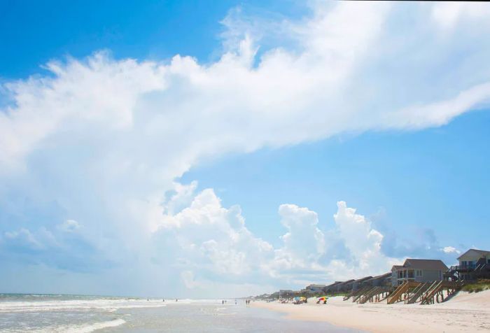 a spacious beach front with homes overlooking the ocean