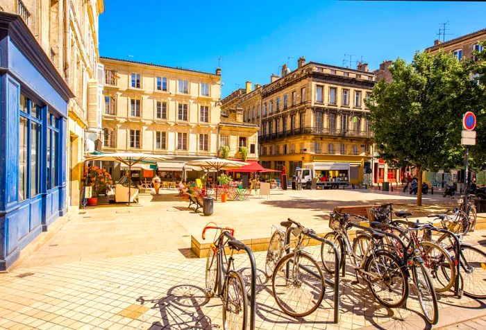 A quaint plaza featuring public bike racks and outdoor cafes.