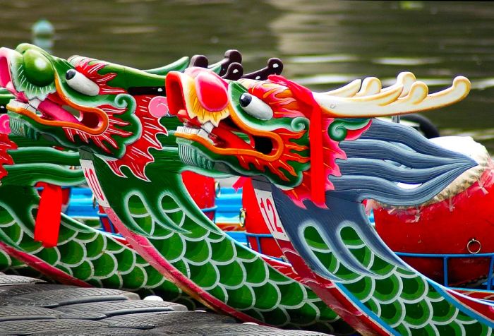 Dragon boats rest peacefully as they dock along the serene waterways.