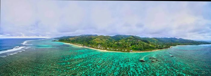 Vibrant blue waters and a coral reef off the coast of Viti Levu, Fiji