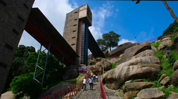 Visitors descend the steps of Olumo Rock in Abeokuta, an ancient site of significance.