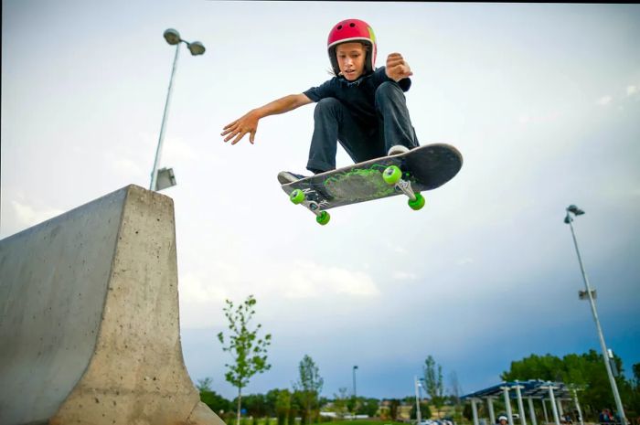 A child catches air on a skateboard at Confluence Park, Denver