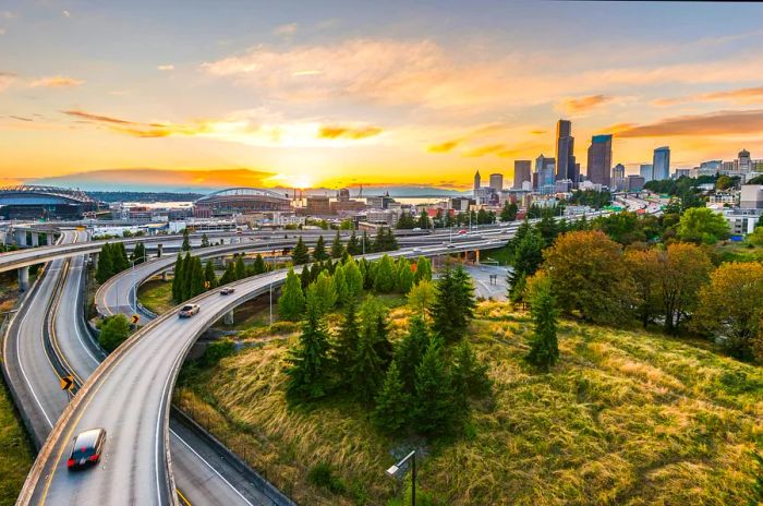 The Seattle skyline and Interstate highways blend beautifully with Elliott Bay and the waterfront during sunset in Seattle, Washington State, USA.